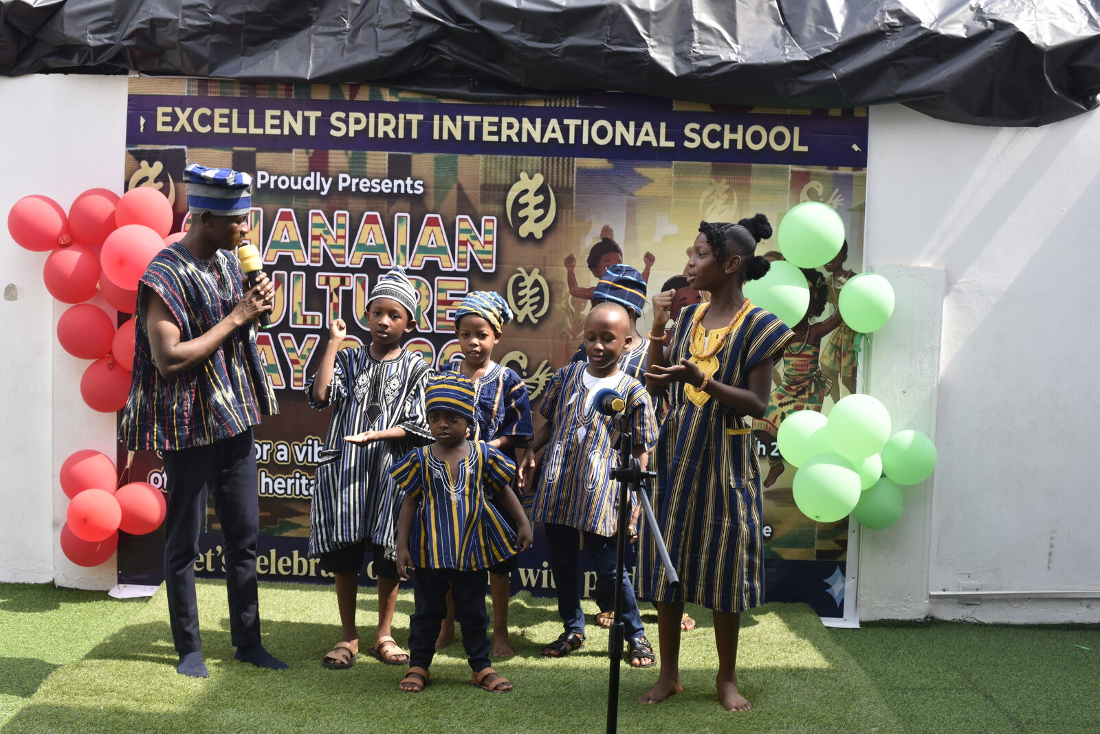 Children in traditional dress performing at the school's Ghanaian Culture Day celebration